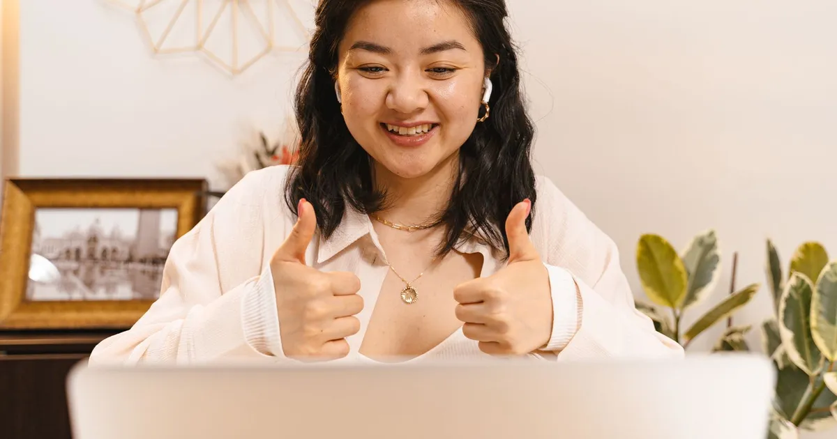 Smiling Canadian borrower approved for installment loans guaranteed approval on a laptop at home