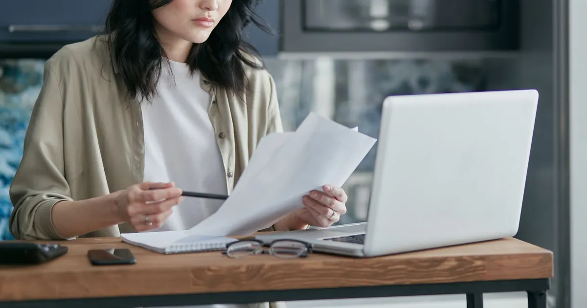 Canadian woman applying for installment loans no income verification on a laptop with no paperwork on the table