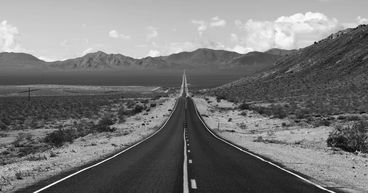 Long straight road at sunrise representing the 24 to 60 month path of long term loans bad credit borrowers repay